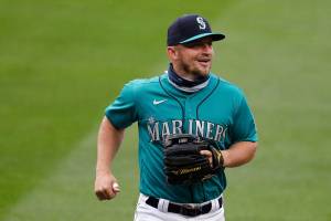 Seattle Mariners' Kyle Seager smiles as he runs off the field during a baseball game against the Oakland Athletics during the Mariners home opener Friday, July 31, 2020, in Seattle. (AP Photo/Elaine Thompson)