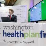 Brad Finnegan demonstrates the Washington Healthplanfinder website following a news conference in 2013 in Seattle. (AP Photo/Elaine Thompson, file)