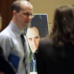 A large photo of slain federal prosecutor Thomas C. Wales is seen between his son Tom Wales (left) and daughter Amy Wales as they talk after a ceremony in a courtroom at the Federal Courthouse in Seattle on Oct. 11, 2006, held to observe the fifth anniversary of his slaying. (AP Photo/John Froschauer, file)