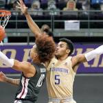 Washington's Jamal Bey (5) defends as Washington State's Isaac Bonton shoots in the first half of an NCAA college basketball game Sunday, Jan. 31, 2021, in Seattle. (AP Photo/Elaine Thompson)