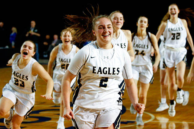 Hailey Hiatt celebrates with her Arlington teammates after hitting a game-winning shot in a victory over Shorecrest on March 5 at the Tacoma Dome. Arlington won 50-49 to advance to the Class 3A Hardwood Classic semifinals. (Kevin Clark / The Herald)
