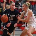 Glacier Peak's Madison Rubino drives around Snohomish's Kaylin Beckman as Snohomish lost to Glacier Peak 50-39 in a non-league girls' basketball game on Monday, Dec. 9, 2019 in Snohomish, Wash. (Andy Bronson / The Herald)