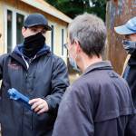 Morgan Zehrung (left), owner of Forecast Solar, talks with homeowner Brian Aikins and builder Jeff Harrell in Everett. (Kevin Clark / The Herald)