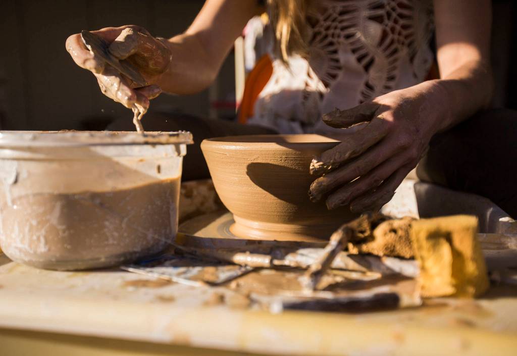Rachel Recker at work on a bowl at Salish Sea Ceramics in Everett. (Olivia Vanni / The Herald)