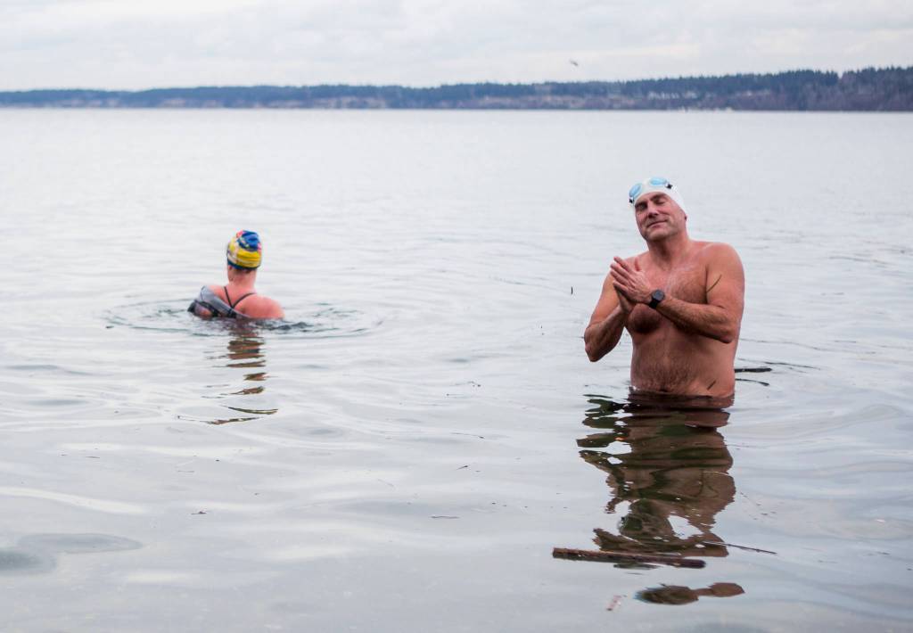 Joe Hempel (right), and Kristin Galbreaith finish their 35-minute, one-mile swim from Seawall Park in Langley. (Olivia Vanni / The Herald)