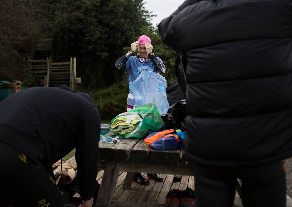 Joe Hempel (left), Kristin Galbreaith and Brian McCleary get prepared to start their swim on Jan. 29 in Langley. (Olivia Vanni / The Herald)
