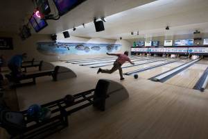 Dennis Shewey, of Arlington, bowls at Evergreen Lanes on Monday, Feb. 1, 2021 in Everett, Washington. Starting Monday, certain categories of Snohomish county businesses were permitted to reinstate indoor occupancy at 25% capacity under Phase 2 of Gov. Jay Inslee’s statewide reopening plan. (Andy Bronson / The Herald)