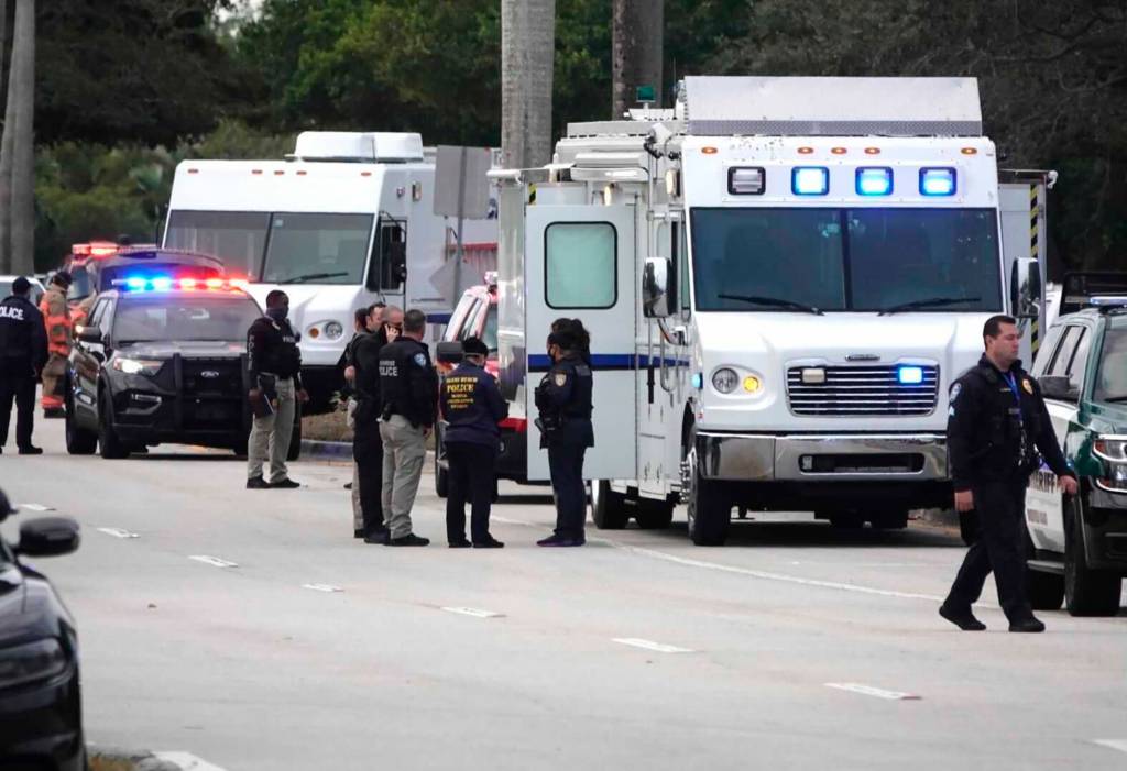 Law enforcement gather near the scene of a shooting that wounded several FBI agents in Sunrise, Fla., Tuesday, Feb. 2, 2021.  (Joe Cavaretta/South Florida Sun-Sentinel via AP)