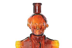 This circa 1876 Simon’s Centennial Bitters bottle represents George Washington when he was commander in chief of the Continental Army, 100 years before. The red amber shaded to yellow amber bottle is 10 inches high and auctioned for $2,640.