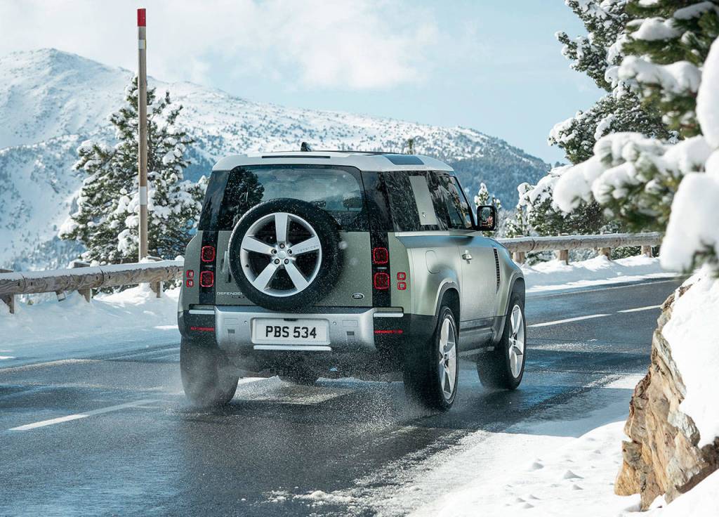 A spare wheel mounted outside on a side-hinged rear door is classic Defender styling. The 2020 Defender 90 model is shown here. (Land Rover)
