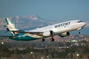 FILE - In this Jan. 21, 2021 file photo, the first commercial flight of the Boeing 737 Max in Canada since the aircraft was cleared to fly again in Canadian airspace lifts off in Calgary.  Boeing is getting a boost from regulators' approval of changes it made to the troubled 737 Max jetliner. The company said Tuesday, Feb. 9,  that it delivered 26 new commercial planes in January, including 21 Max jets.   (Jeff McIntosh/The Canadian Press via AP, File)