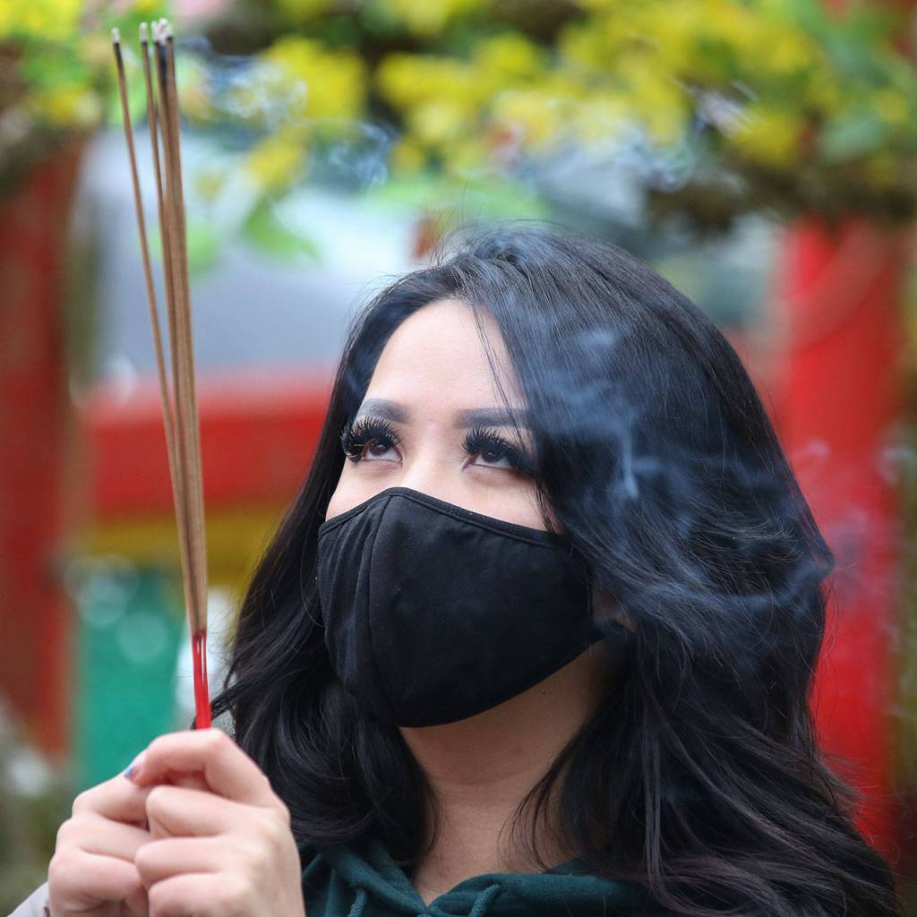 People gathered to offer prayers and wishes for Lunar New Year at Dia Tang Temple in Lynnwood on Friday. (Kevin Clark / The Herald)