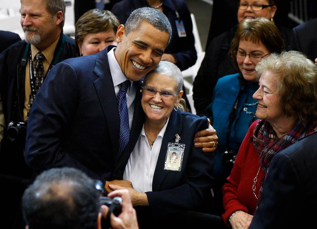 President Obama hugs Sharon OHara on Feb. 17, 2012, after quoting her in his speech at the Boeing airplane manufacturing facility in Everett. (Dan Bates / Herald file)