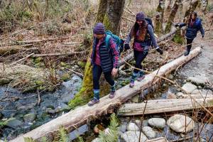 Kendra Swanson, Colleen Fadden and Sara Boyle hike Heybrook Ridge Trail near Index Friday afternoon on February 12, 2021.  (Kevin Clark / The Herald)