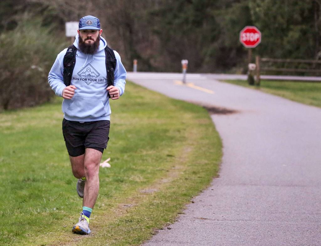Austin Johnson, 26, trains on the Centennial Trail in Lake Stevens and is planning to do a 24-hour run to raise money for the American Foundation for Suicide Prevention. (Kevin Clark / The Herald)
