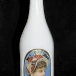 Silly as it may seem, milk glass can be one of many colors. It is an opaque glass first used in the 1800s and now prized in collections of barber bottles of the Victorian era. This 10½-inch-high milk glass barber bottle with a colorful label under glass sold for $200. (Cowles Syndicate Inc.)
