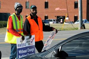 Tray Ragland, left, and Kim Hickerson of the Retail, Wholesale and Department Store Union hold signs outside an Amazon facility where labor is trying to organize workers on Tuesday, Feb. 9, 2021. For Amazon, a successful effort could motivate other workers to organize. But a contract could take years, and Amazon has a history of crushing labor organizing. (AP Photo/Jay Reeves)