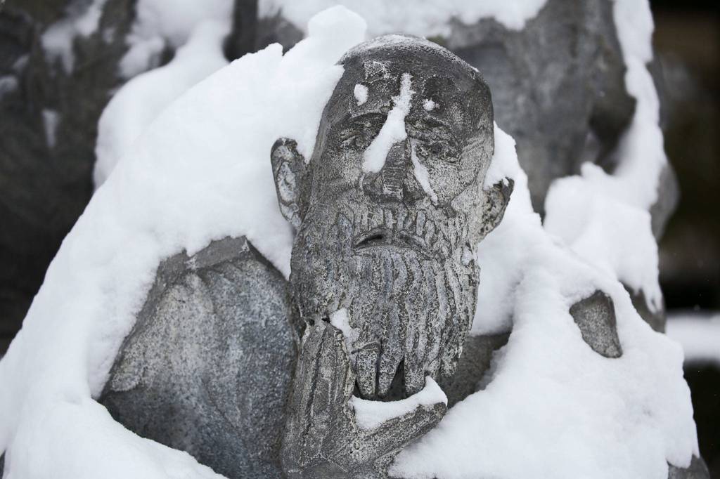 Snow covers the Seeing Whales statue Saturday in Edmonds. (Kevin Clark / The Herald)