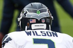 Seattle Seahawks quarterback Russell Wilson (3) dons a helmet sticker as a Walter Payton Man of The Year nominee and says "Breonna Taylor" before an NFL football game against the Washington Football Team, Sunday, Dec. 20, 2020 in Landover, Md. (AP Photo/Daniel Kucin Jr.)