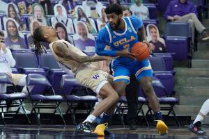 CORRECTS WASHINGTON PLAYER TO HAMEIR WRIGHT, INSTEAD OF NATE ROBERTS - UCLA forward Cody Riley, right, collides with Washington forward Hameir Wright, left, during the first half of an NCAA college basketball game, Saturday, Feb. 13, 2021, in Seattle. (AP Photo/Ted S. Warren)