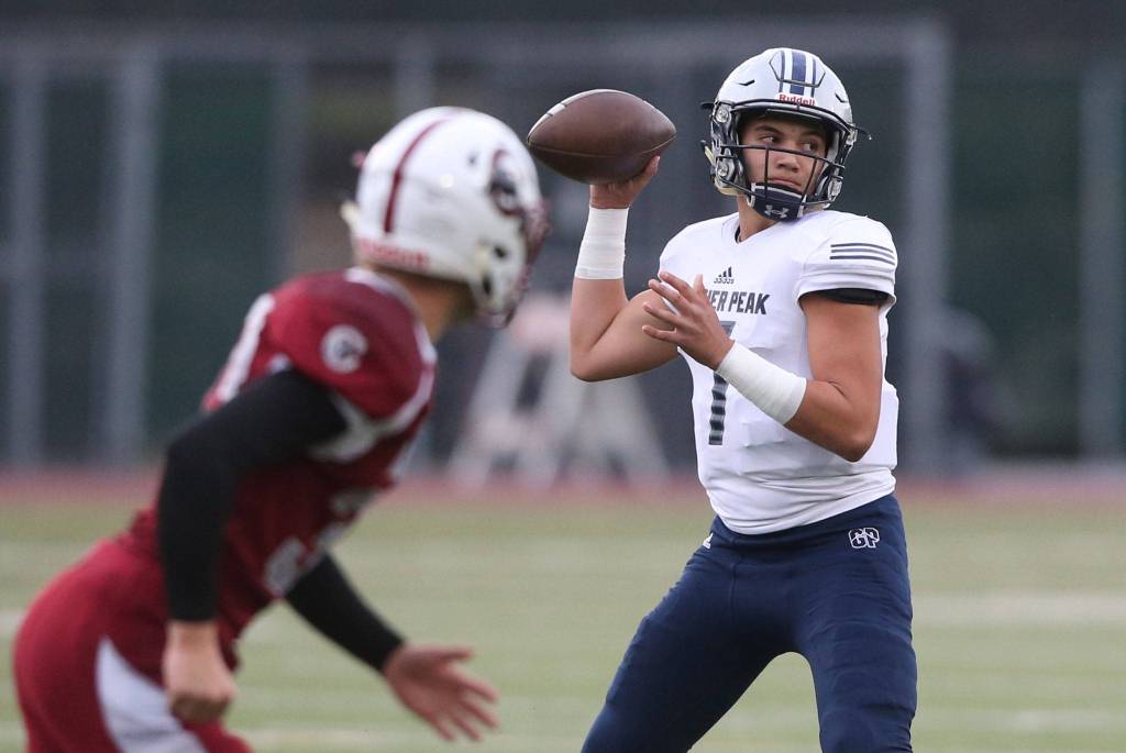 Glacier Peak quarterback Tyson Lang looks to throw during a game against Cascade at Everett Memorial Stadium on Oct. 4, 2019 in Everett. (Andy Bronson / The Herald)