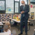 Washington Gov. Jay Inslee speaks with kindergartners in Chelsea Singh's class during a visit to Firgrove Elementary School in Puyallup, Wash., Thursday, Feb. 18, 2021. Students are back in school and all teachers and students are wearing masks. (Ellen M. Banner/The Seattle Times via AP, Pool)