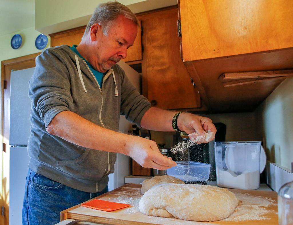 Gerry Betz makes bread Saturday morning at his home in Everett. (Kevin Clark / The Herald)