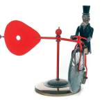 This folk art whirligig shows President Theodore Roosevelt with his monocle and top hat riding a cycle while holding a red paddle that catches the wind and spins. It sold at auction for hundreds of dollars. (Cowles Syndicate Inc.)