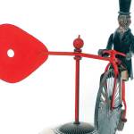 This folk art whirligig shows President Theodore Roosevelt with his monocle and top hat riding a cycle while holding a red paddle that catches the wind and spins. It sold at auction for hundreds of dollars. (Cowles Syndicate Inc.)