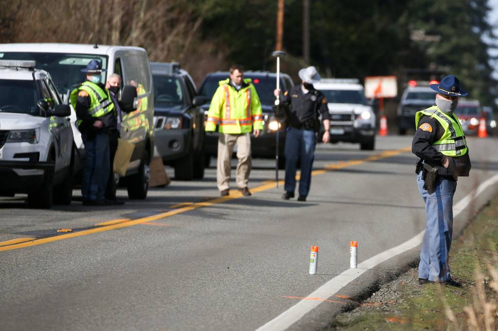 Washington State Patrol officers examine the scene of a hit and run double fatality in Bothell Friday on February 19, 2021. (Kevin Clark / The Herald)