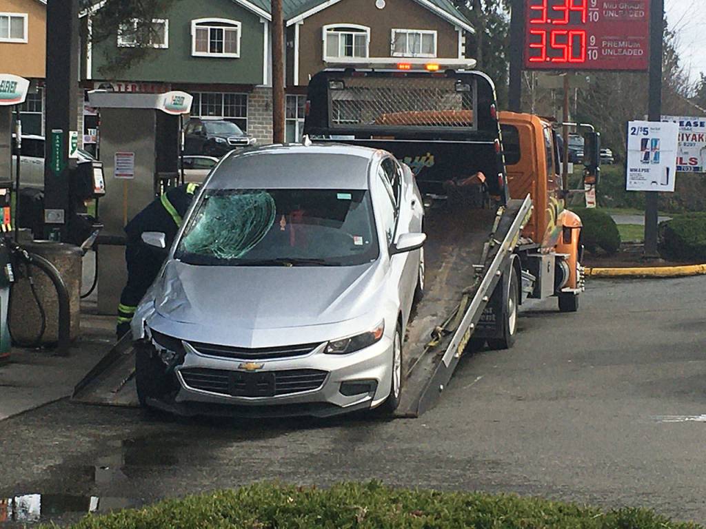A suspects car is towed from the scene near a fatal hit and run Friday north of Bothell. (Kevin Clark / The Herald)