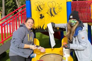 Everett mothers Heather Patackas, left, and Kimberly Mehlhoff got together with others to clean up graffiti at the newly opened Forest Park playground on Friday. (Photo courtesy of Laura Boucock)