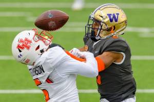 American Team wide receiver Marquez Stevenson of Houston (5) has his pass broken up by National Team defensive back Keith Taylor Jr. of Washington (8) before it was intercepted by National Team defensive back Damar Hamlin of Pittsburgh (33) during the NCAA Senior Bowl college football game in Mobile, Ala., Saturday, Jan. 30, 2021. (AP Photo/Matthew Hinton)
