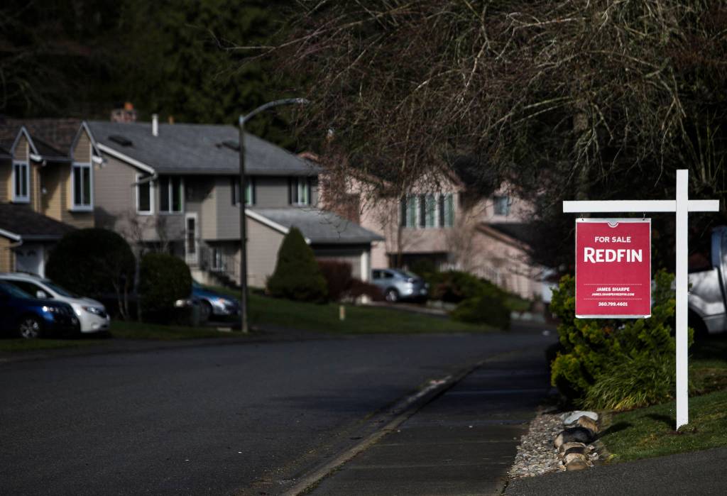 A Redfin For Sale sign Wednesday in front of a home in the Silver Firs neighborhood in Everett. (Olivia Vanni / The Herald)