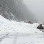 Snow comes down onto U.S. 2 at Stevens Pass by way of avalanche control. (Washington State Department of Transportation)