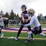 Quarterback Tanner Jellison runs a play with running backs Jay Roughton (left) and Trayce Hanks as the Lake Stevens High School football team conducts its first practice, marking the first day of practice for fall sports in the Wesco division, on Monday in Lake Stevens. (Andy Bronson / The Herald)