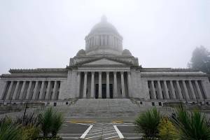 FILE - In this Jan. 7, 2021, file photo, the Legislative Building is shown partially shrouded in fog at the Capitol in Olympia, Wash. Washington state's richest residents, including Bill Gates and Jeff Bezos, would pay a wealth tax on certain financial assets worth more than $1 billion under a proposed bill whose sponsor says she is seeking a fair and equitable tax code. Under the bill, starting Jan. 1, 2022, for taxes due in 2023, a 1% tax would be levied not on income, but on "extraordinary" assets ranging from cash, publicly traded options, futures contracts, and stocks and bonds. (AP Photo/Ted S. Warren, File)