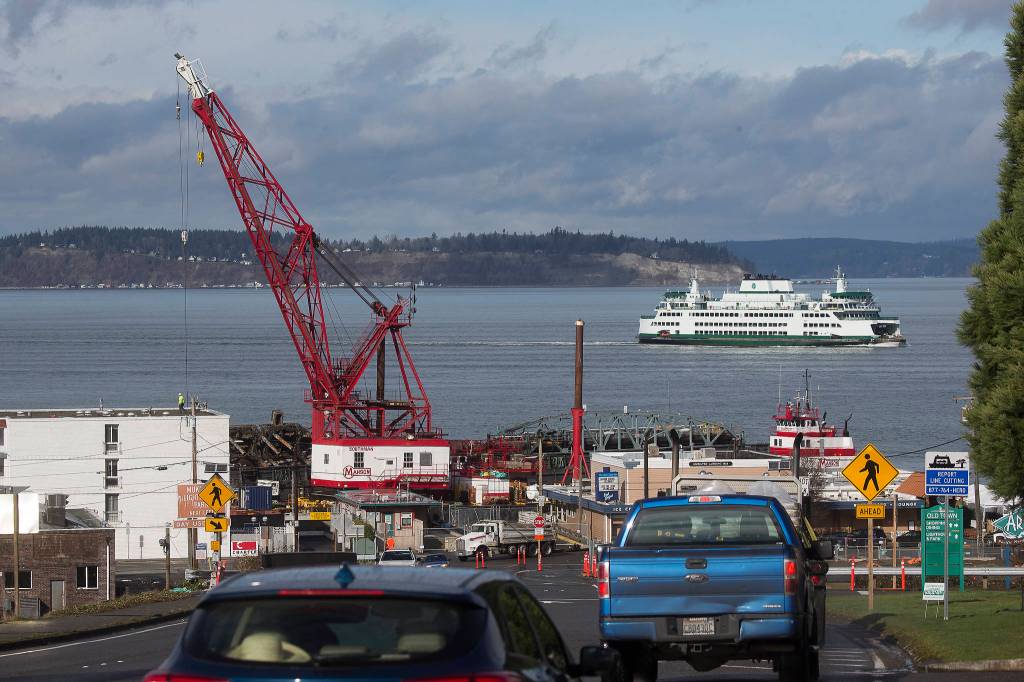 A ferry passes by the remains of the Mukilteo ferry dock ramp and pier on Tuesday. (Andy Bronson / The Herald)