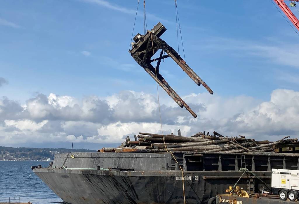 Crews remove a bridge seat tower during the demolition of the transfer span and decking at the old Mukilteo ferry dock. (Washington State Department of Transportation)