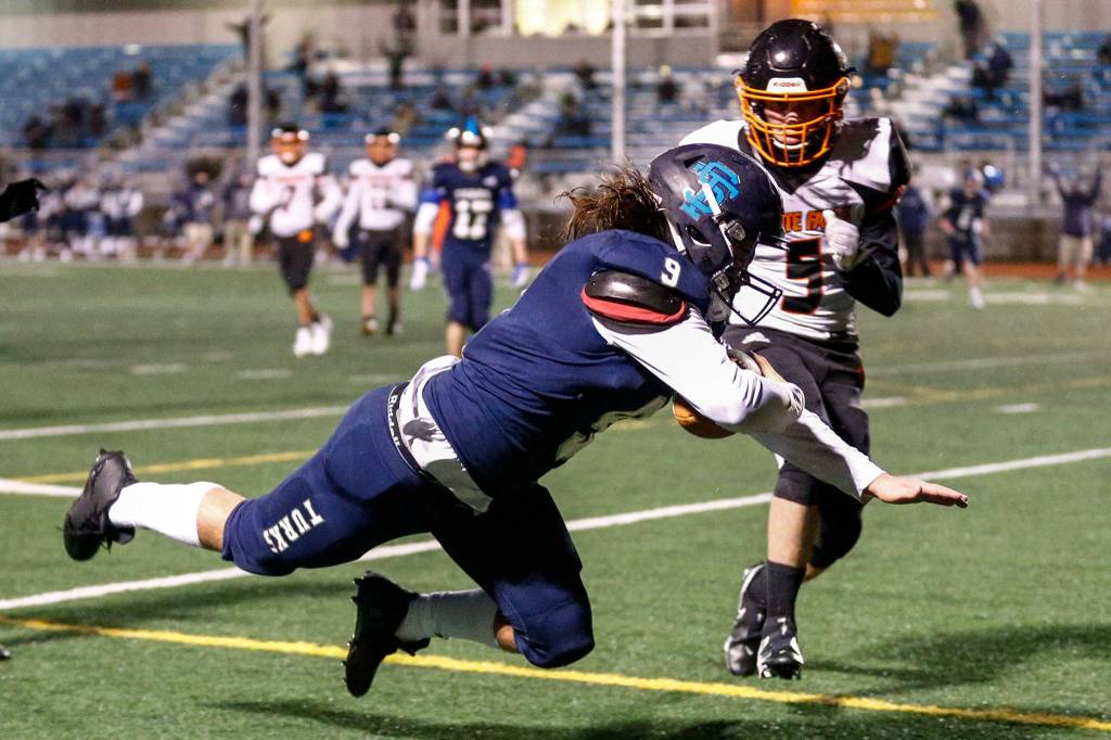 Sultans Zane Sailor scores a touchdown with Granite Falls Jace Stevens looking on Friday night in Sultan on February 26, 2021 (Kevin Clark / The Herald)