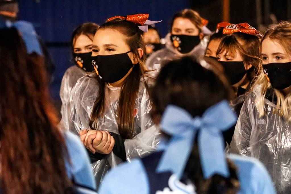 The Granite Falls High School cheerleaders greet Sultan cheerleaders Friday night in Sultan on February 26, 2021 (Kevin Clark / The Herald)