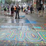 In this June 30 photo, a sign on the street reads Welcome to CHOP as protesters stand near barricades, at the CHOP (Capitol Hill Occupied Protest) zone in Seattle. (AP Photo/Ted S. Warren, File)