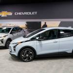 The 2022 Bolt EV (foreground) and EUV are shown in Milford, Mich. Automakers are rolling out multiple new electric vehicle models as the auto industry responds to stricter pollution regulations worldwide and calls to reduce emissions to fight climate change. (Carlos Osorio / Associated Press)