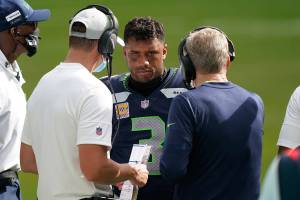 Seattle Seahawks head coach Pete Carroll, right, talks to quarterback Russell Wilson (3) during the second half of an NFL football game, Sunday, Oct. 4, 2020 in Miami Gardens, Fla. The Seahawks defeated the Dolphins 31-23.(AP Photo/Wilfredo Lee)