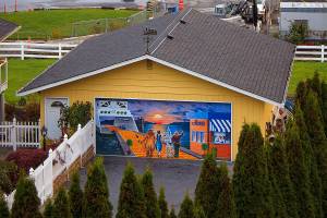 This longtime mural on a garage door in Mukilteo can be seen mainly from the Mukilteo Speedway overpass sidewalk. (David Welton/This is Whidbey)