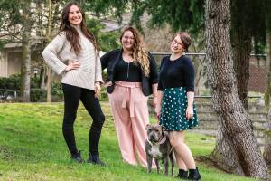 Erin Staadecker (left-right) Jael Weinburg and Kaylee Allen with Rosie formed the Edmonds firm Creative Dementia Collective. The company helps memory care patients and care-givers by providing art, music and other creative therapies. (Kevin Clark / The Herald)