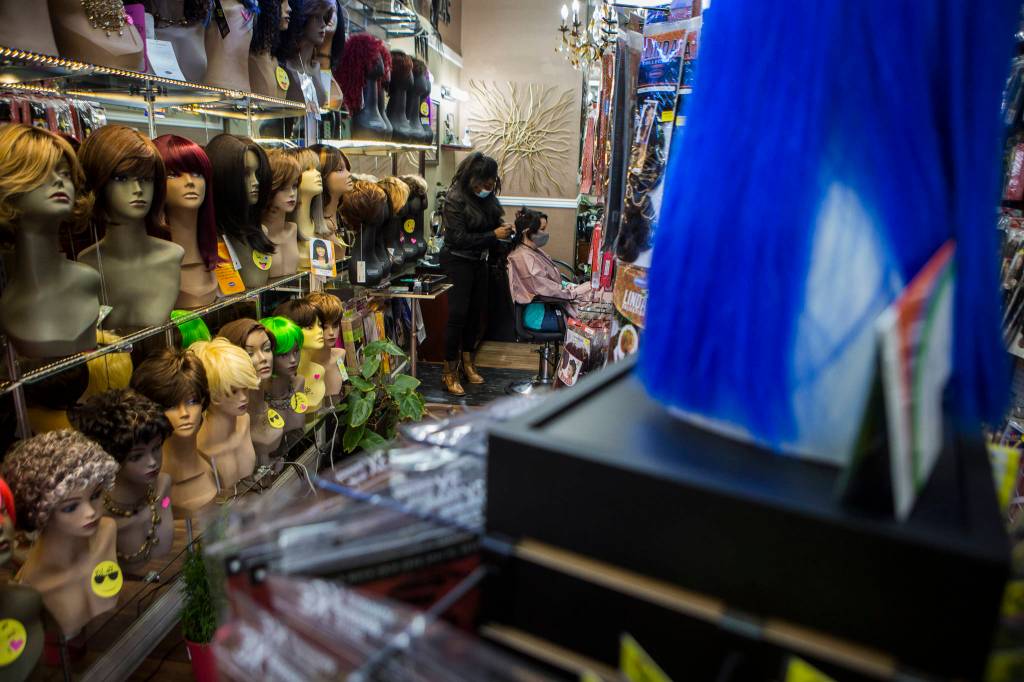 Wigs and hair extensions line the walls and display racks of Decarlas Beauty Supply & Salon in Everett. (Olivia Vanni / The Herald)