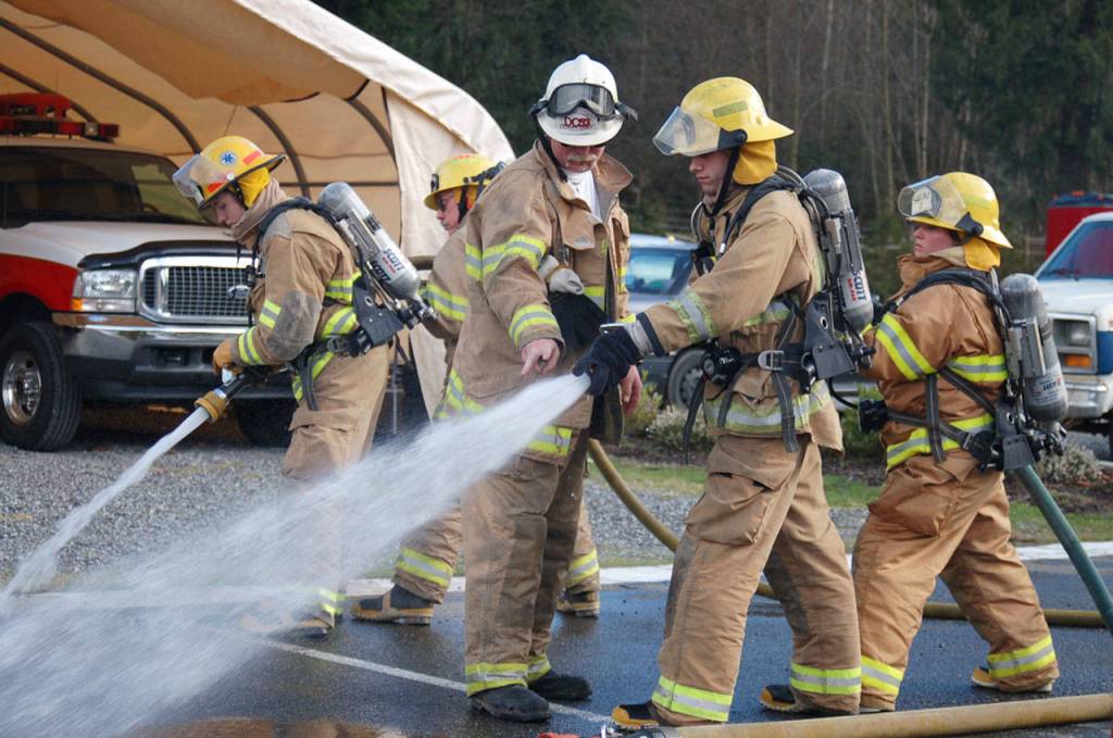 Isaac Howard (center) gives directions during a training session with Snohomish County Fire District 26 in Gold Bar. (Bobbie Lange)