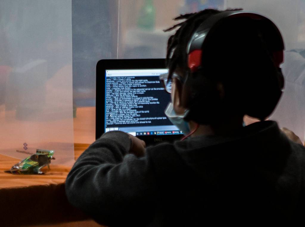 Elwin Pittman writes code for fun after school at the Safe Haven WiFi Cafe in Everett. (Olivia Vanni / The Herald)