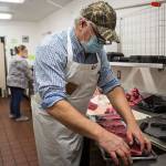Kevin Ashe, right, and his daughter Carly Nations prep meat before opening on Wednesday, March 3, 2021 in Darrington, Wa. (Olivia Vanni / The Herald)